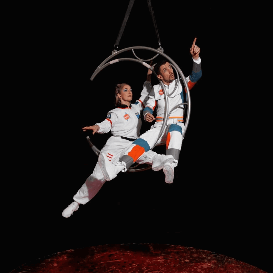 Image of two acrobats from a show called into space